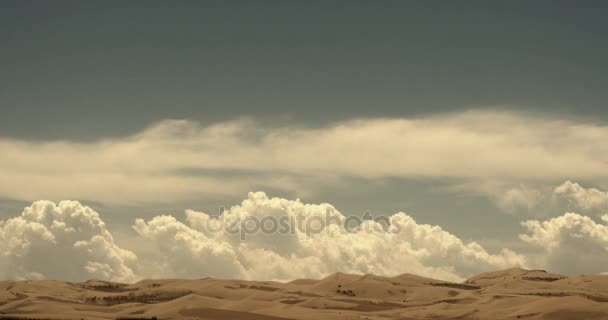 4k timelapse large white puffy cloud mass rolling over desert sand dunes. - Footage, Video