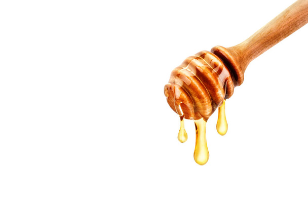 Delicious fresh honey dripping off the spoon. - Foto, Imagem