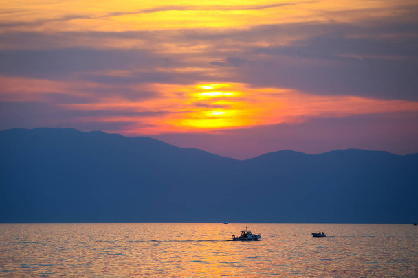 Sunset with boats at sea - Fotó, kép