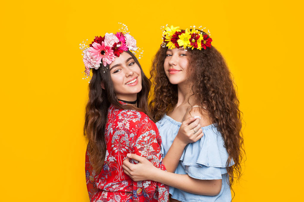 two girls wearing floral wreaths  - Valokuva, kuva