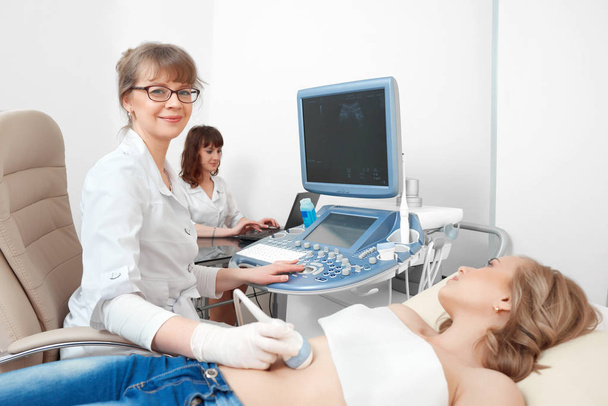 Young woman getting ultrasound scanning examination at the hospi - Фото, зображення