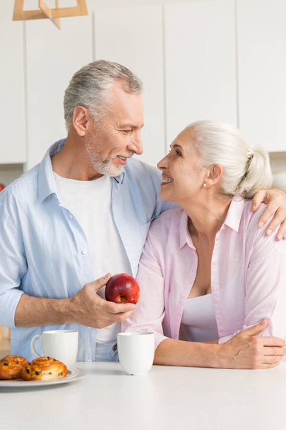 Mature loving couple family standing at the kitchen - Photo, image