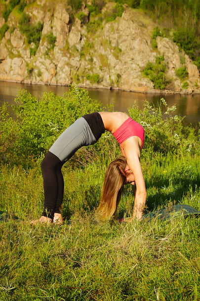 Young beautiful woman doing peacefully yoga outdoors - 写真・画像