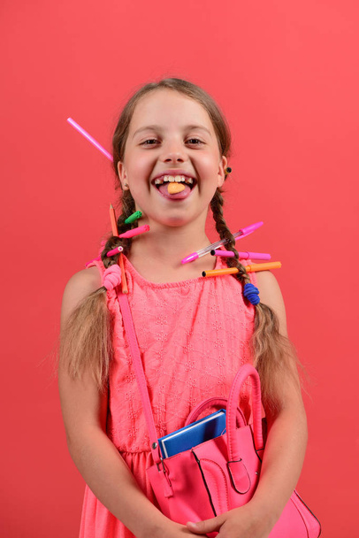 Kid in pink dress with braids and colored pencils - Fotografie, Obrázek