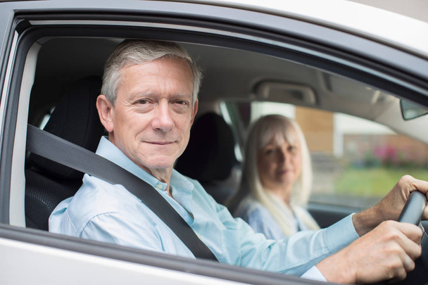Portrait Of Smiling Senior Couple On Car Journey Together - Photo, Image