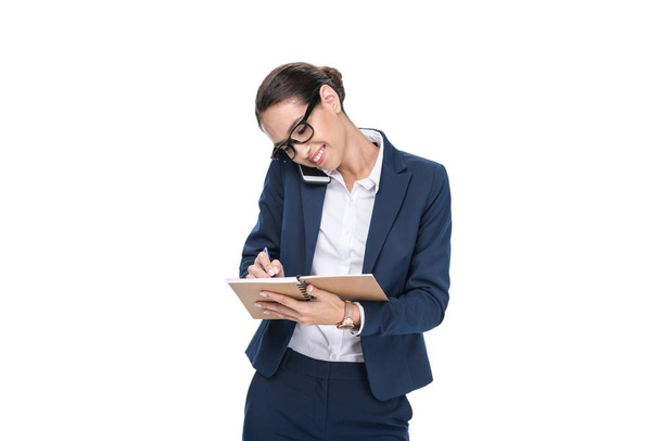 businesswoman writing in notepad - Фото, зображення
