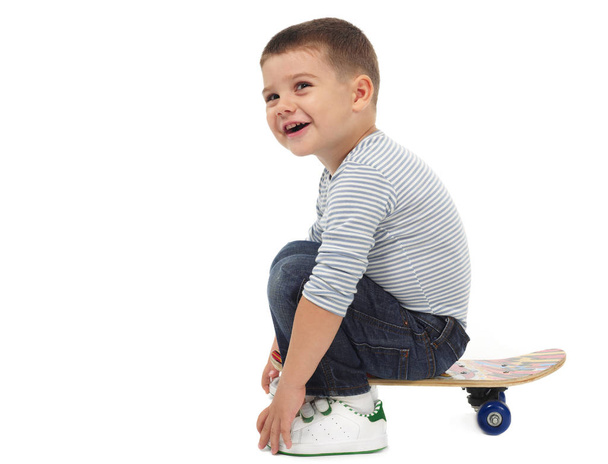 Happy kid with skateboard - Фото, изображение