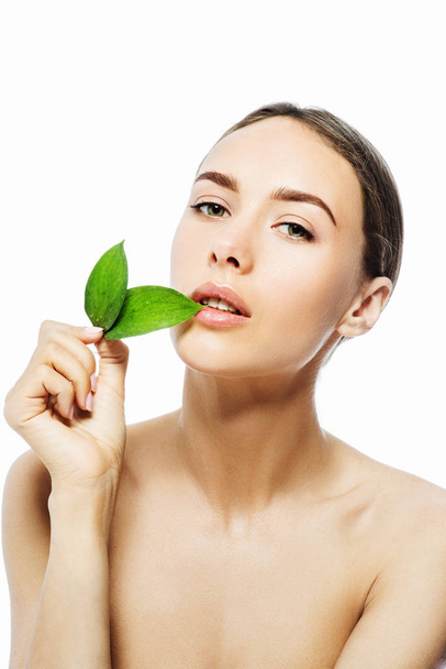 Beautiful woman face with green leaf - Foto, imagen