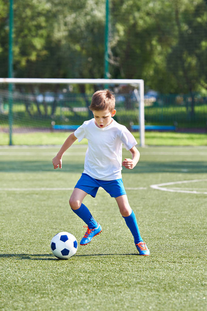 Boy soccer player running with ball - Photo, Image