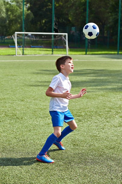 Boy soccer playing with ball - Фото, изображение