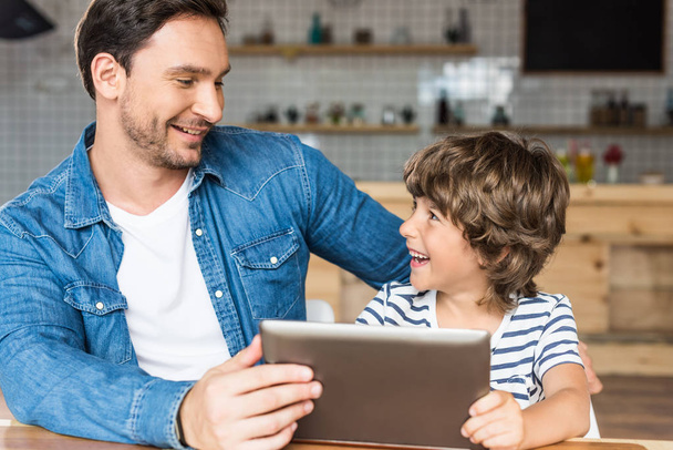 son and father using tablet - Photo, Image