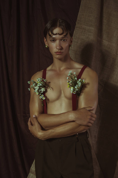 Sexy young guy with flowers from underarms - Fotoğraf, Görsel