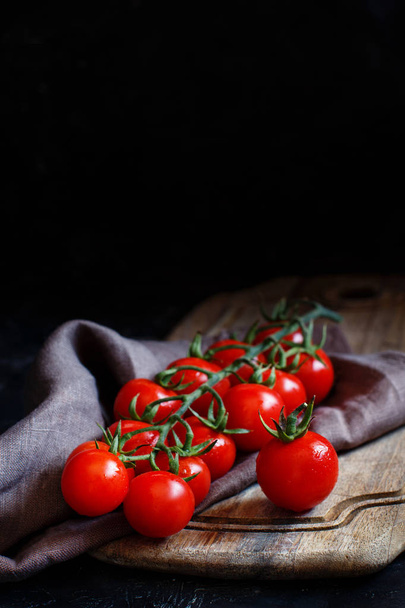 Cherry tomatoes on a dark background - Fotografie, Obrázek