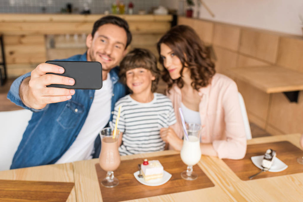 family taking selfie in cafe - Photo, Image