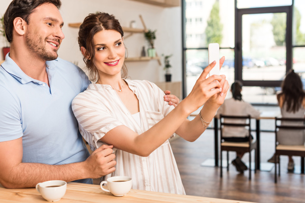 couple taking selfie in cafe - Фото, изображение