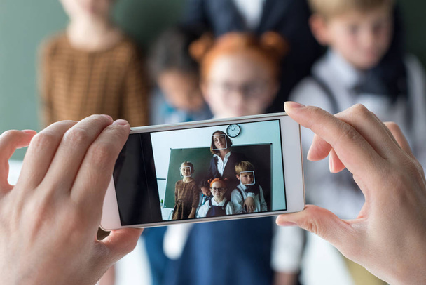 teacher and students photographing with smartphone - Photo, Image