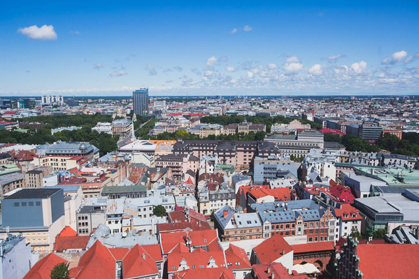 Beautiful super wide-angle panoramic aerial view of Riga, Latvia with harbor and skyline with scenery beyond the city, seen from the St. Peters Church observation tower - Foto, Imagen