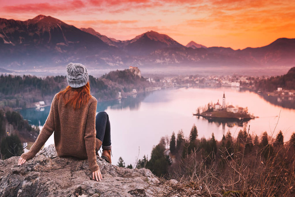 Traveling young woman looking on sunset on Bled Lake, Slovenia,  - Fotografie, Obrázek