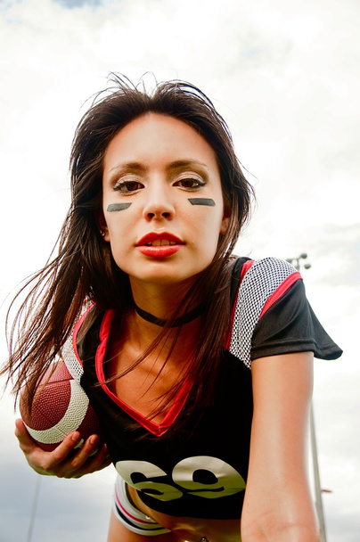 Woman wearing American football top - Foto, Imagen