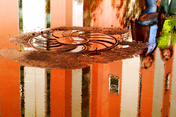 City. Reflection in puddle - Фото, изображение