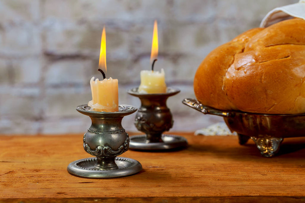 Shabbat with lighted candles, challah bread and wine. - Photo, Image