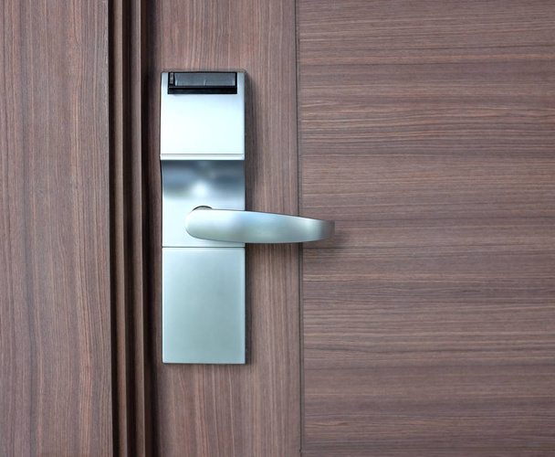 modern stainless with card insert handle on wood door - Φωτογραφία, εικόνα
