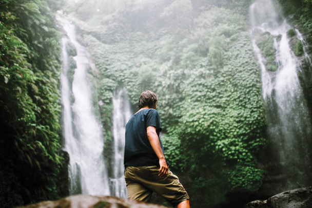 man standing near waterfall  - Foto, Imagem