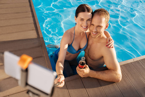 Happy couple taking selfies in pool - Foto, Imagem