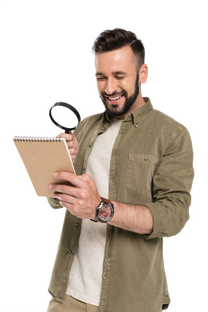 man with magnifying glass and notebook - Foto, Bild