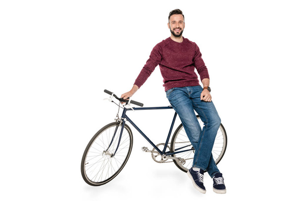 man leaning on bicycle - Фото, зображення
