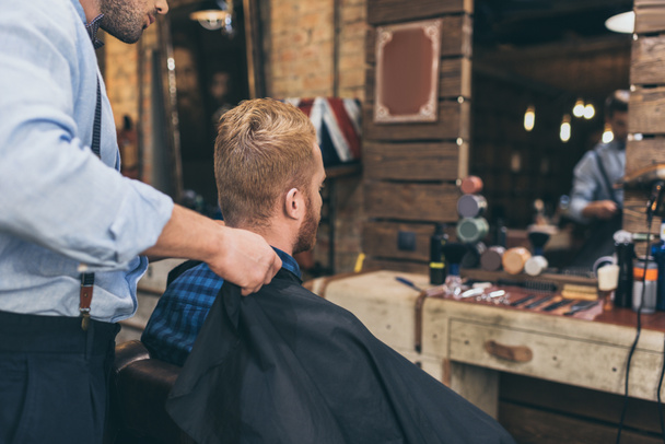 barbero con cliente en peluquería
 - Foto, imagen
