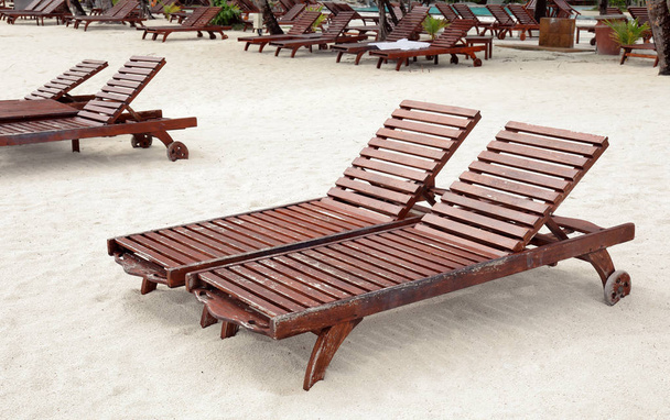 Sun loungers on tropical beach - 写真・画像