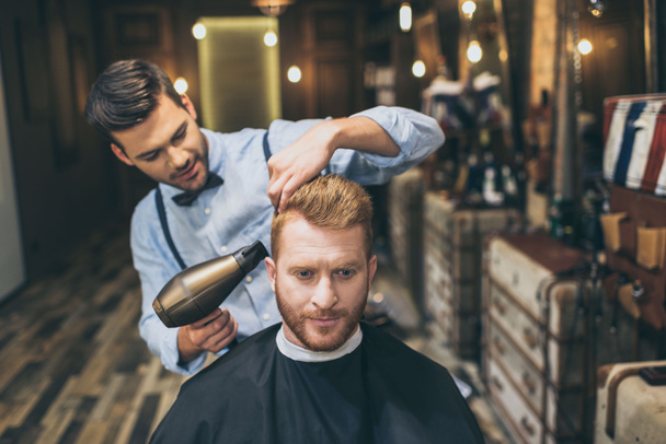barber drying hair of customer - Photo, Image