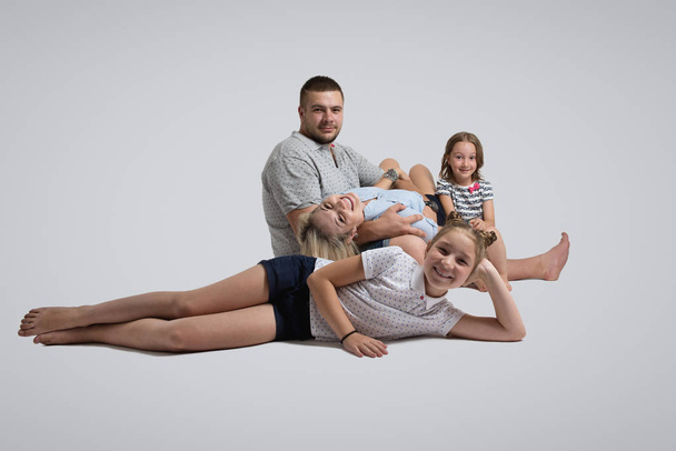 Young family lying on floor  - Photo, image