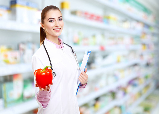 Nutritionist with pepper and clipboard at pharmacy - Foto, Imagem