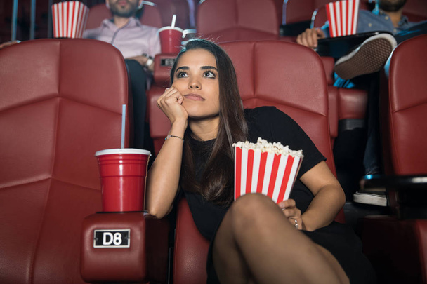 Bored woman in cinema - Fotoğraf, Görsel