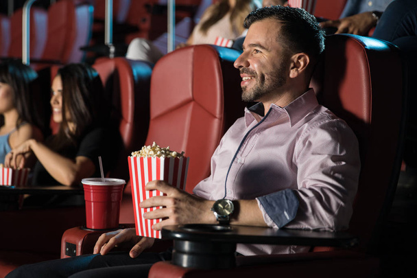 Young man watching movie at cinema - Photo, Image