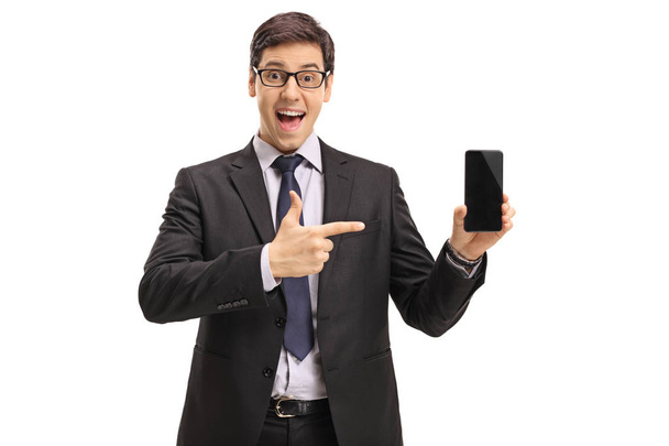 Businessman showing a phone and pointing - Foto, afbeelding