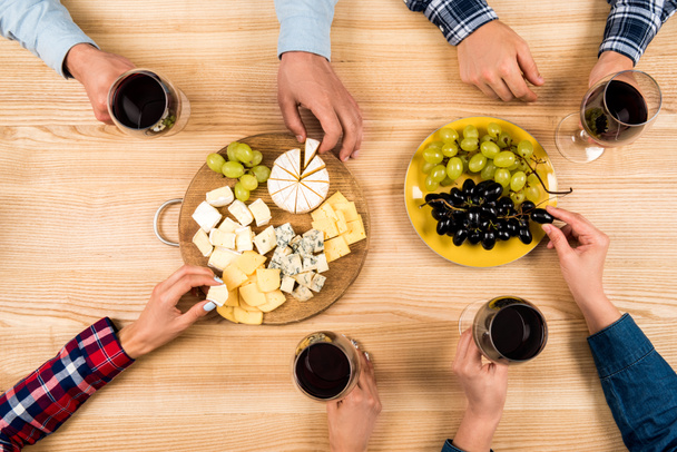 amigos comiendo queso y bebiendo vino
 - Foto, Imagen