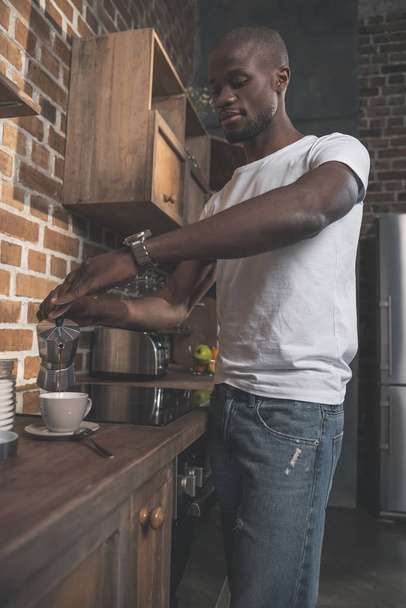 African american man preparing coffee - Fotó, kép