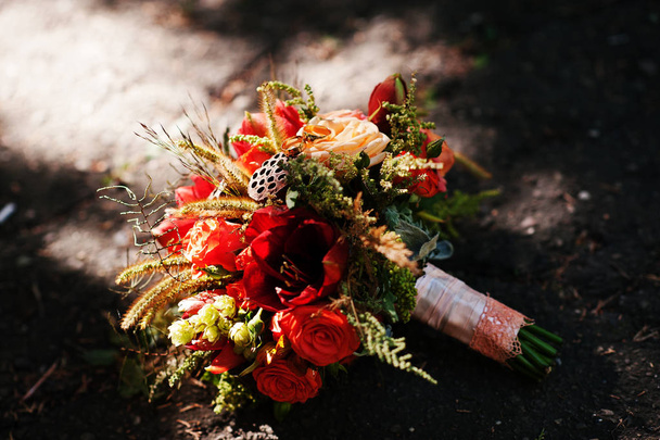 Close-up photo of isolated bridal bouquet laying on the ground. - Zdjęcie, obraz