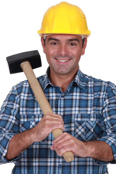 Tradesman holding a rubber mallet - Foto, afbeelding