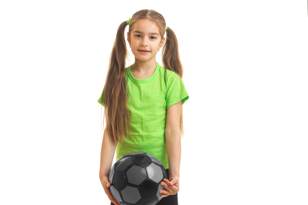 little girl plays with ball in studio - Foto, imagen