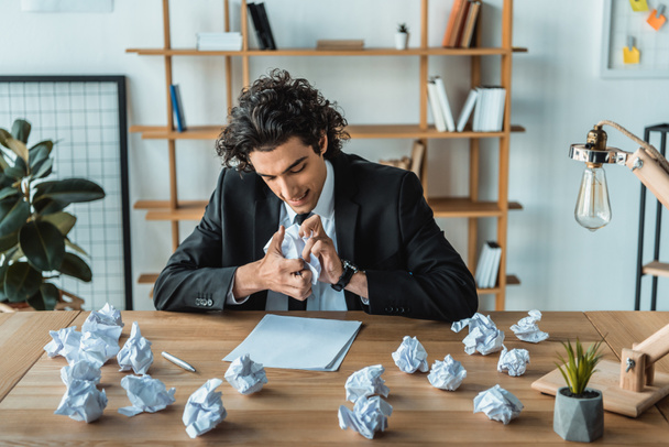 angry businessman crumpling papers at workplace - Fotoğraf, Görsel