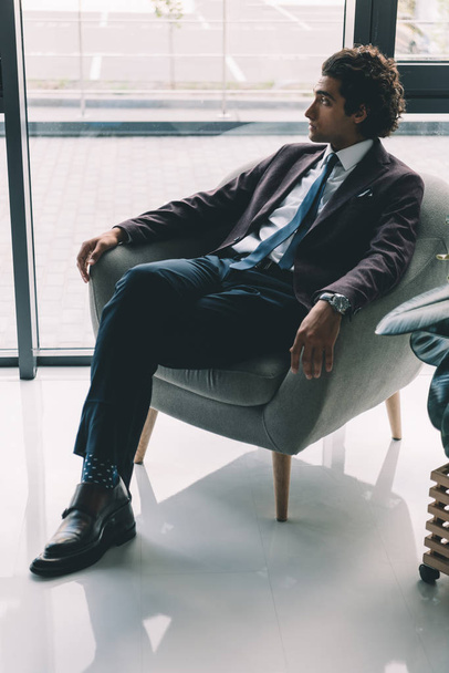 businessman resting in armchair in office - 写真・画像