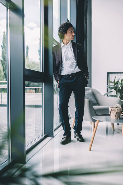 businessman standing at window in office - Valokuva, kuva