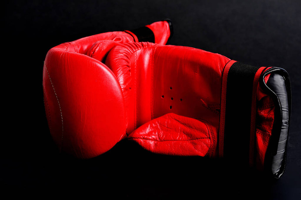 Martial arts equipment concept with bright red boxing mittens - Fotó, kép