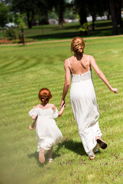 mother and daughter walking at park - Photo, Image