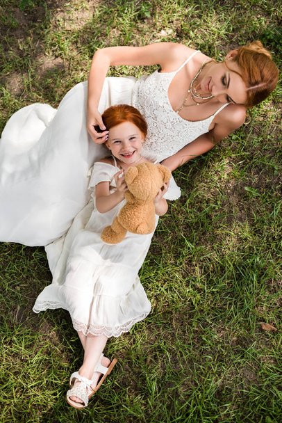 mother and daughter with teddy bear in park - Fotoğraf, Görsel