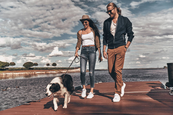 beautiful couple walking with dog - Foto, Imagem